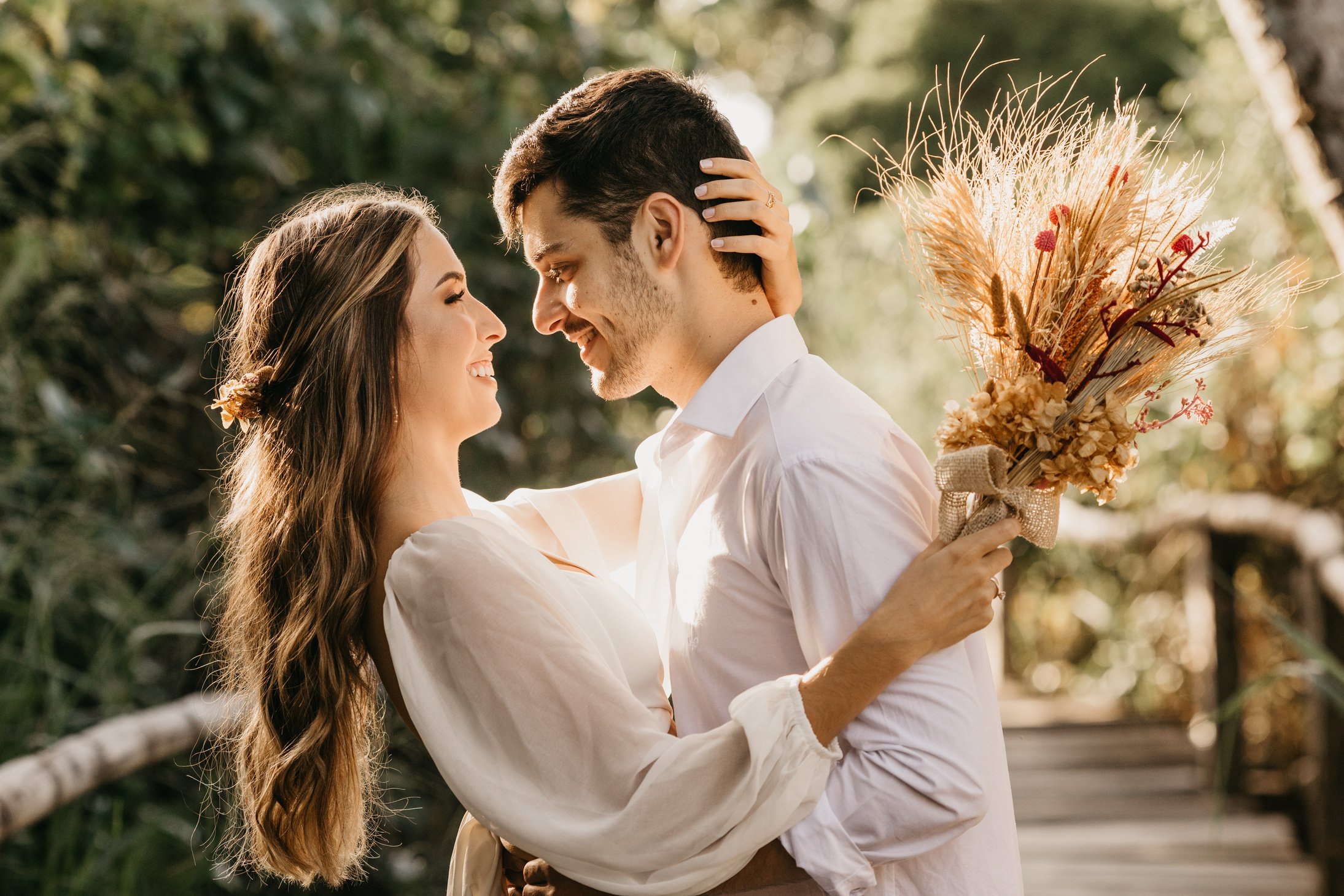 Bride and groom embracing outdoors